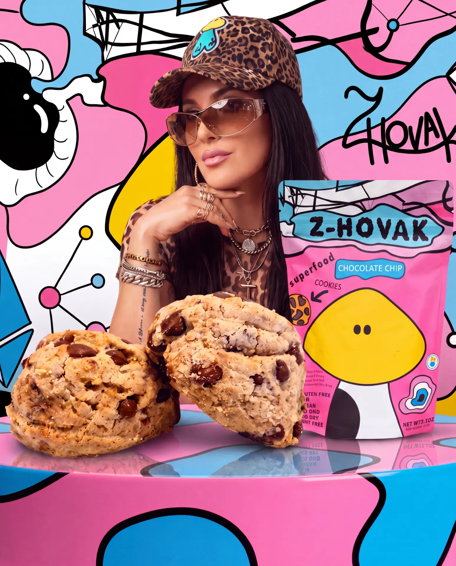 Z Hovak with chocolate chip cookies and a pink Z-Hovak pouch against a vibrant pop-art mural
